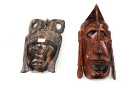 A West African carved ebony mask and an East African wooden mask. Max.