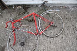 Two vintage bicycle frames and spares.