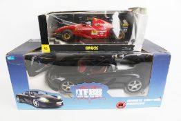 A TFBB (Toys for Big Boys) remote control Porsche and a Onyx Formula 1 Model.