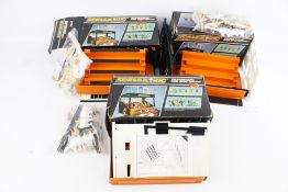 A collection of three Scalextric grandstands and spectator sets. Appear complete, boxed.