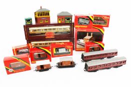 An assortment of OO gauge coaches, wagons and accessories.