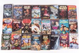 A collection of Star Wars and Star Trek fiction paperback books.
