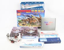 An assortment of commercial aircraft kits and diecast models.