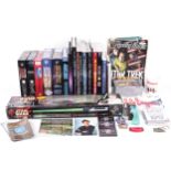 A collection of Star Trek books, PC games & a 'Lightsaber'.