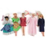 A collection of four Barbie dolls with clothes and accessories. Including 'Dream Store' items, etc.