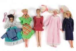 A collection of four Barbie dolls with clothes and accessories. Including 'Dream Store' items, etc.