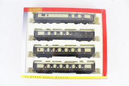 A set of four Pullman OO gauge coaches.