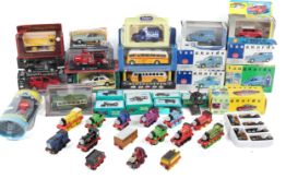 A collection of assorted diecast model cars and Thomas the Tank engine trains.