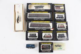 A collection of N gauge locomotives and wagons.