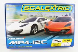 A Scalextric McLaren MP4-12C set. Containing cars, track, controllers, etc.