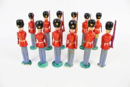A set of twelve wooden models of soldiers.