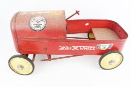 A vintage Skid X Whizz red tin plate pedal car.