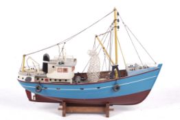 A vintage model of a fishing trawler boat.