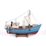 A vintage model of a fishing trawler boat.