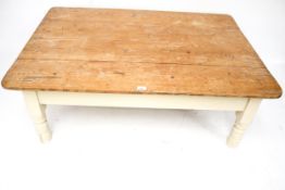 A rectangular pine top coffee table. With cream painted base.