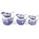 A 19th century Wedgwood set of three graduated blue and white jugs. The largest 17.