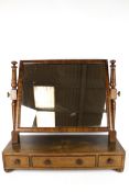 A vintage mahogany swing dress mirror with three drawers.