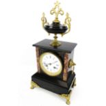 A black slate marble eight-day mantel clock.