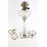 A collection of silver plate to include a Corinthian column candlestick later adapted as an oil