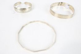 Three vintage white metal bangles. Including a Victorian belt design, etc. 37.