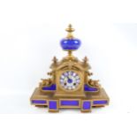 A brass and blue enamel eight-day mantel clock.