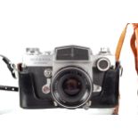 A Miranda Sensorex 35mm SLR camera and a pair of binoculars. With a 50mm f1.