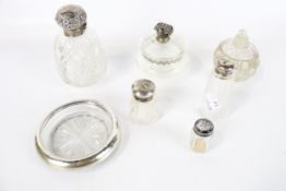 Seven cut glass and hallmarked silver containers. Including scent bottles, etc.