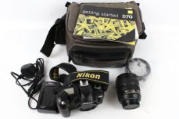 A Nikon D70 digital SLR camera with bag and accessories.