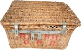 A large wicker basket with iron clasp and rope handles.