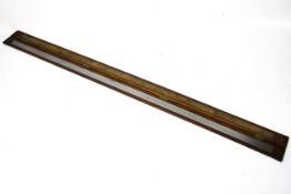 A 2 meter steel Chesterman ruler in a fitted wood case