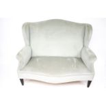 A 20th century wing back two seater sofa.