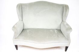 A 20th century wing back two seater sofa.