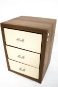 A contemporary wooden bedside cabinet.