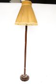 A mid-century wooden standard lamp.