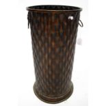 A contemporary relief metal umbrella stand. Of cylindrical form with lion ring handles, H58.