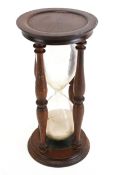 A reproduction mahogany 'hour glass' egg timer.