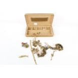 A jewellery box of yellow metal items. Including rings, watch, brooch, etc.