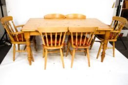 A contemporary pine kitchen table and six chairs.