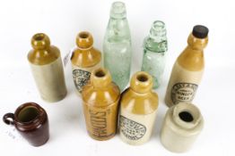 A collection of vintage bottles. Comprising glass and stoneware examples, marked 'W.