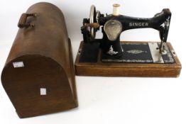 A vintage Singer sewing machine, Y877351. Hand crank, with some accessories, cased.