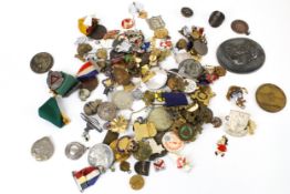 A large collection of badges, medallions, brooches and commemorative medals.