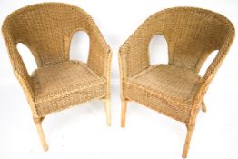 A pair of bamboo and rattan armchairs.