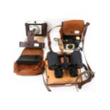 A pair of Schooner 8x30 binoculars and three cameras.