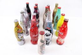 A collection of novelty Coca-Cola bottles.