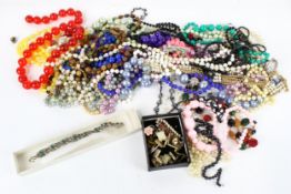 An assortment of costume jewellery. Including a watch and silver ring, etc.