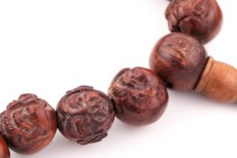 A string of 19th century(?) Chinese carved wood prayer beads.