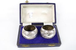 A pair of Indian white metal napkin rings. Boxed, 50.