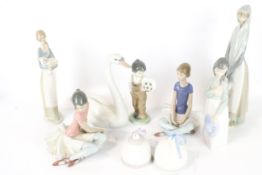 A collection of assorted Lladro and Nao figures.