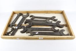 A wooden tray containing steam engine spanners stamped 'Crossley Bros. Ltd'.