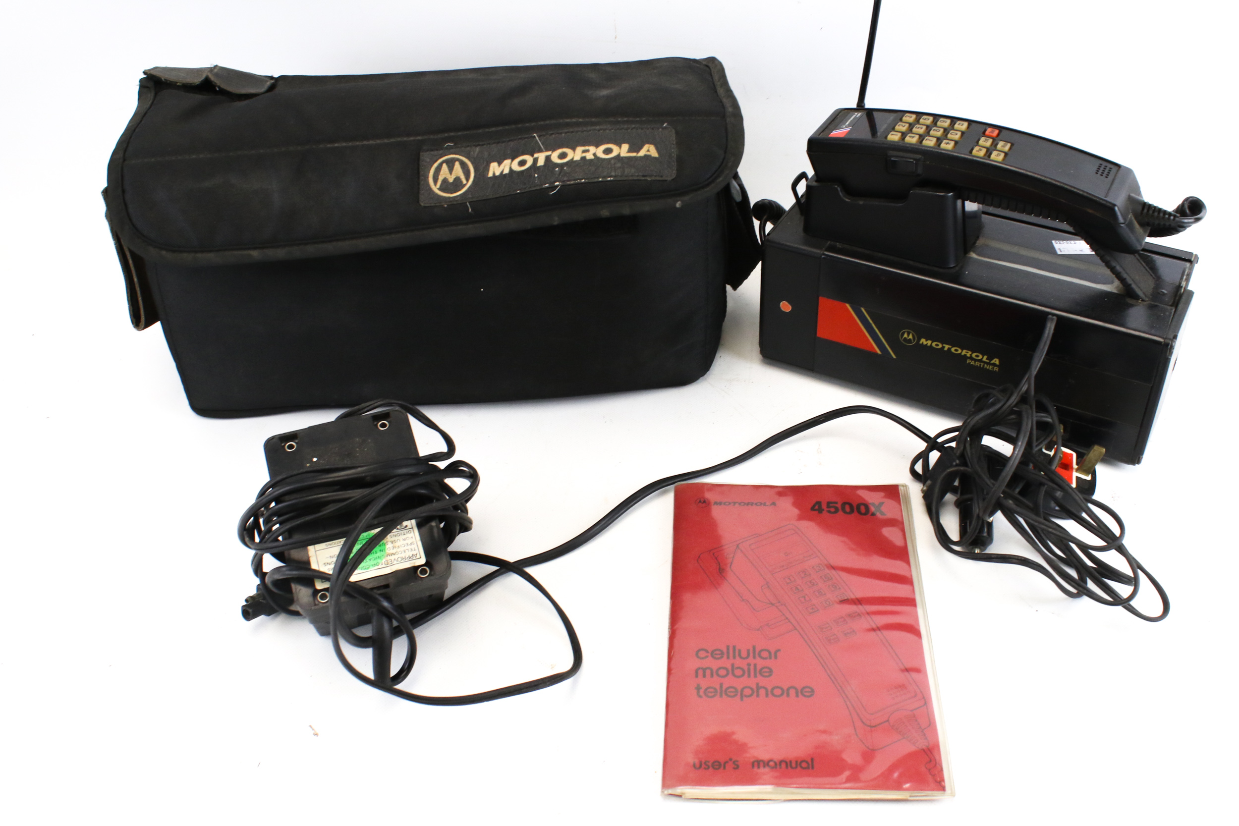 A vintage Motorola Partner 4500X mobile cellular telephone and case.